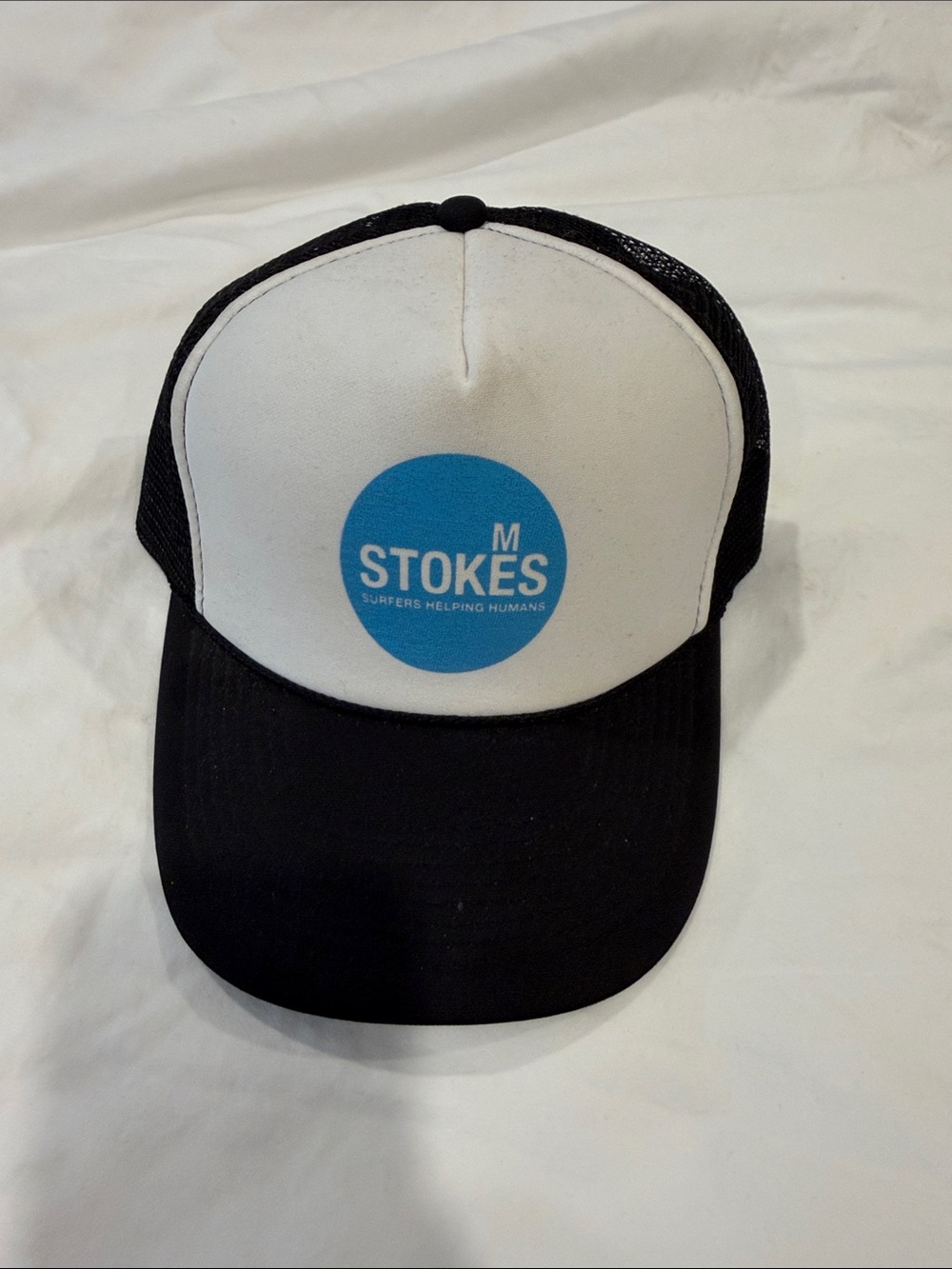 M STOKES “Surfers helping humans” Trucker Hat